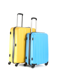 Packed suitcases on white background