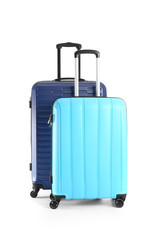 Packed suitcases on white background