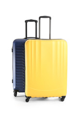 Packed suitcases on white background