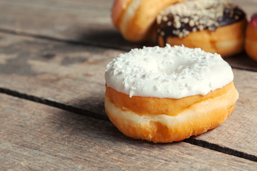 Glazed donuts on wooden background