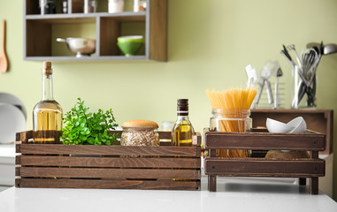 Wooden boxes with products on table in kitchen