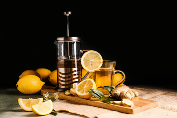 Healthy tea with lemon and ginger on table