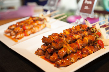 Thai street food BBQ, Pork satay skewer topped with sauce