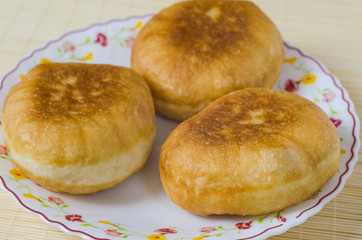 Traditional Russian meat pies belyashi on a plate.