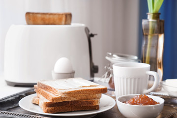 Tasty breakfast with toasted bread on metal tray