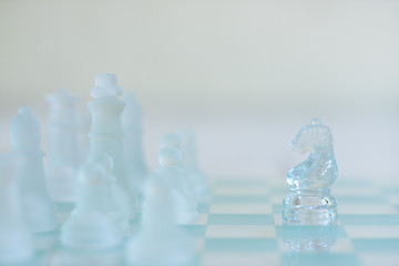 Chess board game made of glass, business competitive concept
