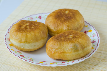 Traditional Russian meat pies belyashi on a plate.