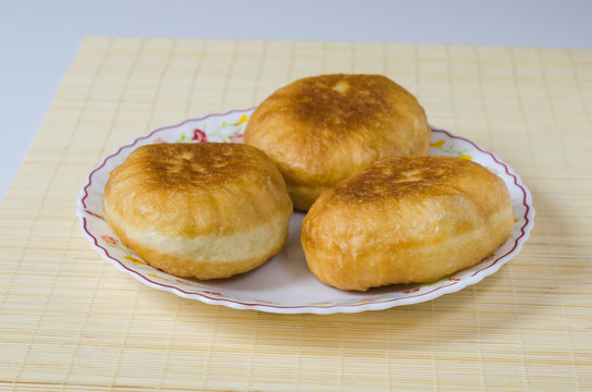 Traditional Russian meat pies belyashi on a plate.