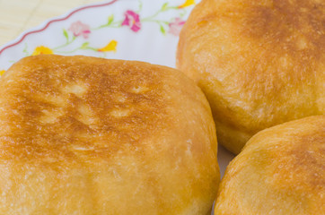 Traditional Russian meat pies belyashi on a plate.