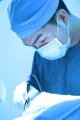 Fototapeta premium veterinarian surgery in operation room take with art lighting and blue filter