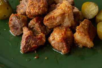 pieces of baked meat on a green platter