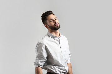 Fashionable young man on light background