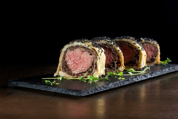 Meatloaf baked in dough and sprinkled with black sesame.
