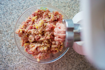 Preparation of mincemeat in house conditions by means of the electric meat grinder, the top view