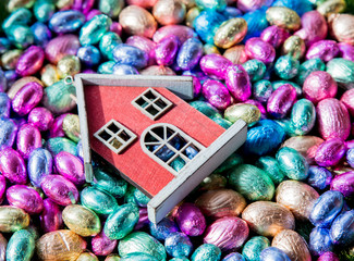 Chocolate Easter eggs and toy house on it