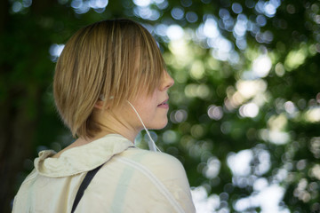 Portrait of a woman with a short haircut in headphones