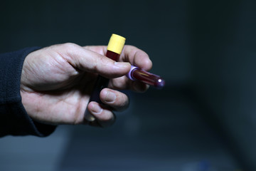 lab worker is taking blood with syringe