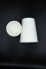 paper cup isolated on black background.