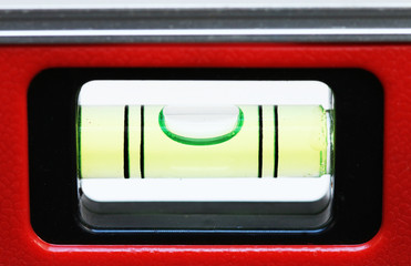 Level tool with red aluminum steel alloy body and green water bar for precise measurement