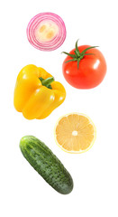 Falling flying vegetables bell pepper, onion, lemon, cucumber, tomato isolated on white background with clipping path.