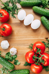 Top view delicious vegetables and eggs with garlic on a wooden table for mouth-watering covers
