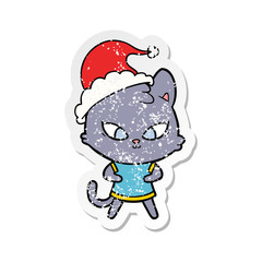 cute distressed sticker cartoon of a cat wearing santa hat