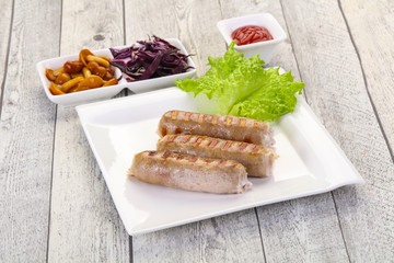 Grilled sausages served mushrooms and cabbage