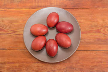 Easter eggs on the brown dish on a rustic table