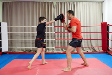 Fototapeta na wymiar Kickboxer kid and his coach
