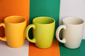 multi-colored ceramic cup on a colorful background