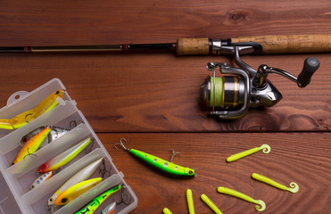 Fishing tackle wooden background. Equipment for spinning fishing.