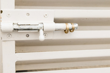 Two gold wedding rings on door lock.metallic