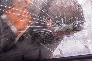 Car knocks a man. Broken car windshield with a man. Crash.
