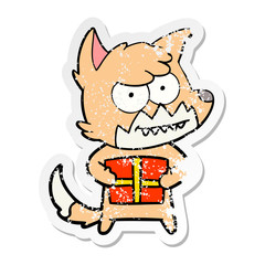 distressed sticker of a cartoon grinning fox with present