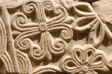 Romanesque decorations carved in the stone wall of an ancient medieval church