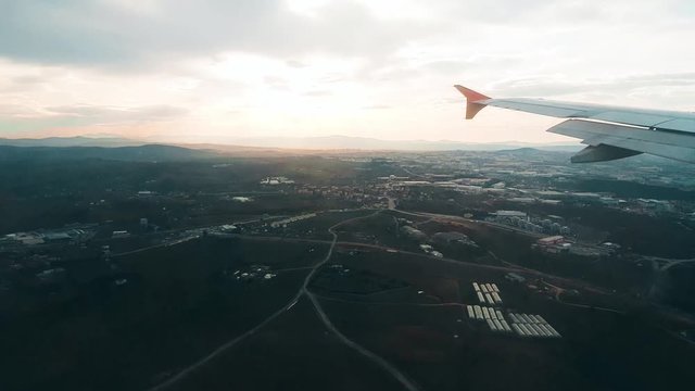 Airplane landing at the airport, view from the window.