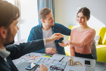 Couple buy or rent apartment together. Cheerful delightful young woman reach hand and get keys from...