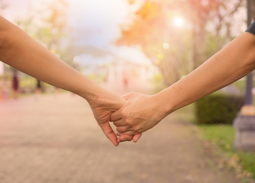 Woman and man holding Shake hands, Happy couple love in the garden.