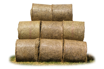 Stacked like a pyramid, bales of straw, tightened mesh . Feed and bedding for livestock on a dairy farm. Side view . Isolated photo .