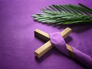 Good Friday, Lent Season and Holy Week concept - A religious cross and palm leaves on purple...
