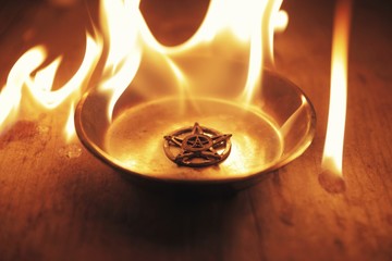 Old pentagram burning in flames