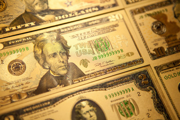 Currency US golden dollar banknotes close-up background.