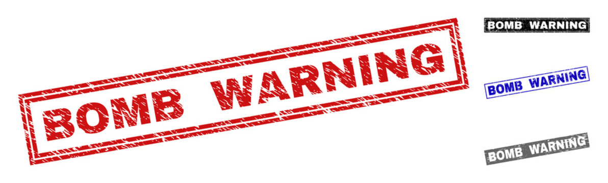 Grunge BOMB WARNING rectangle stamp seals isolated on a white background. Rectangular seals with grunge texture in red, blue, black and grey colors.