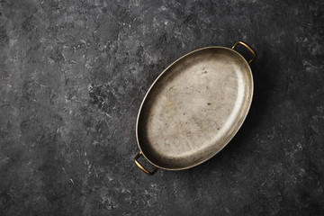 Empty old pan dark stone background top view