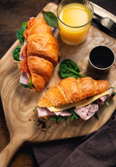Fresh croissant sandwiches orange juice wooden table