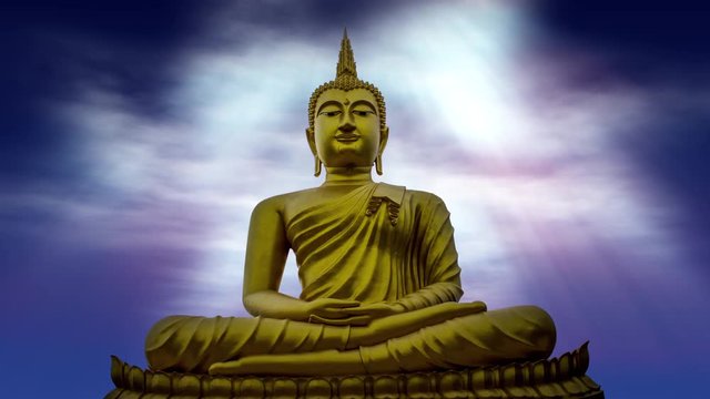Heavenly rays of light shining down on the Golden Gautama Buddha