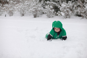 Fototapeta na wymiar Baby crawling in the with snow