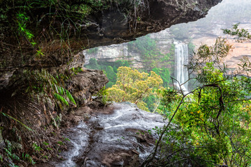 Natures window to a waterfall viewed through the cliff ledge