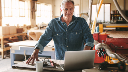 Mature male carpenter in his workshop