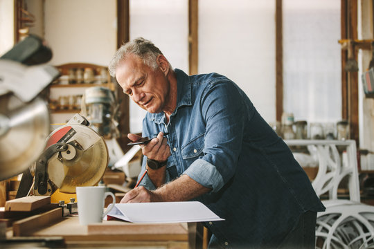 Senior carpenter working at his workshop